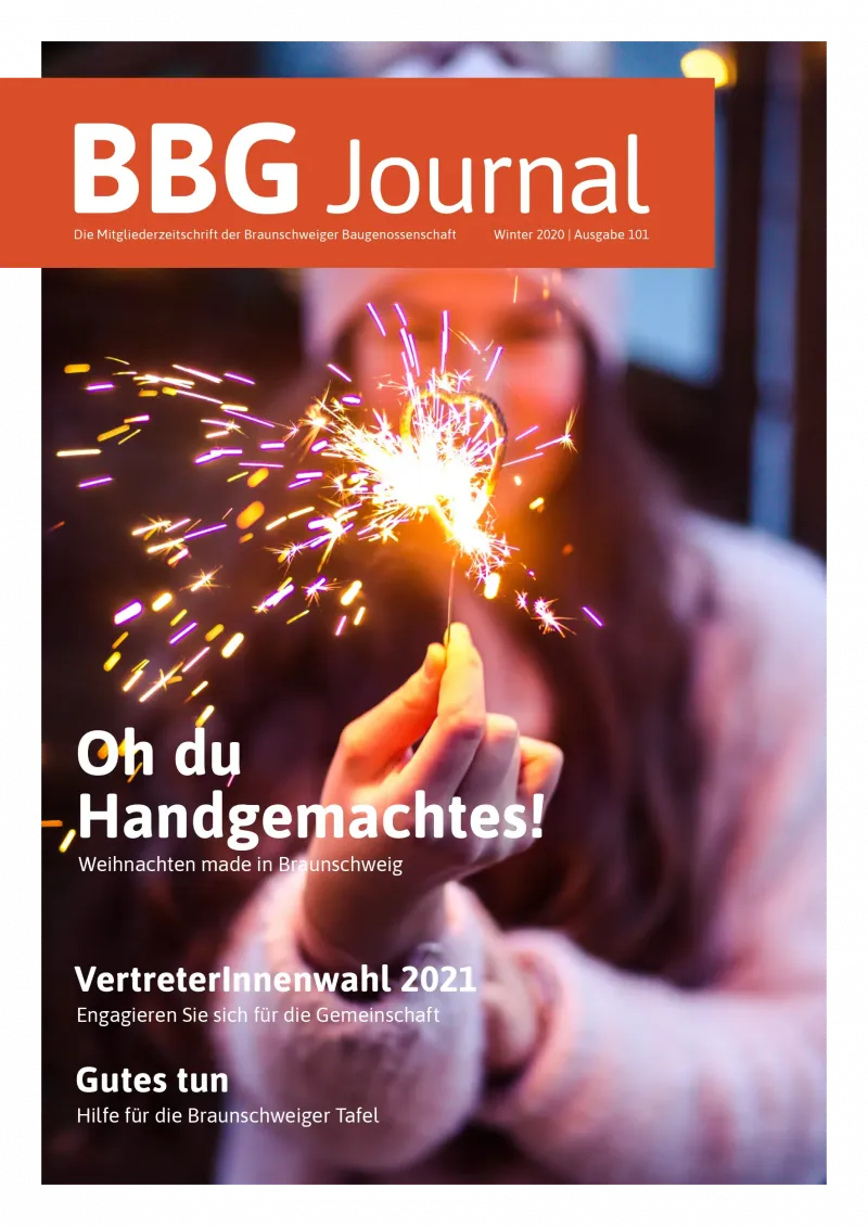 Eine Person, die einen beleuchteten Diamanten hält, mit einem festlichen, verschwommenen Hintergrund und festlichen Zeitschriftentexten.
