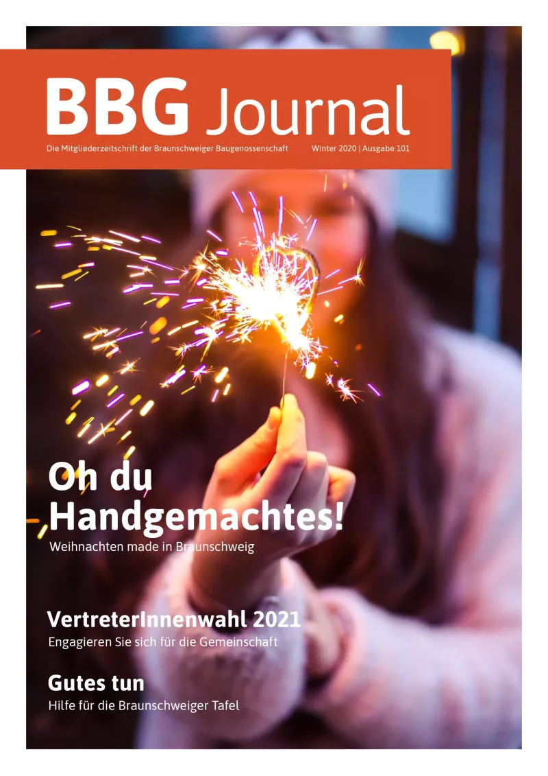 Eine Person, die einen beleuchteten Diamanten hält, mit einem festlichen, verschwommenen Hintergrund und festlichen Zeitschriftentexten.