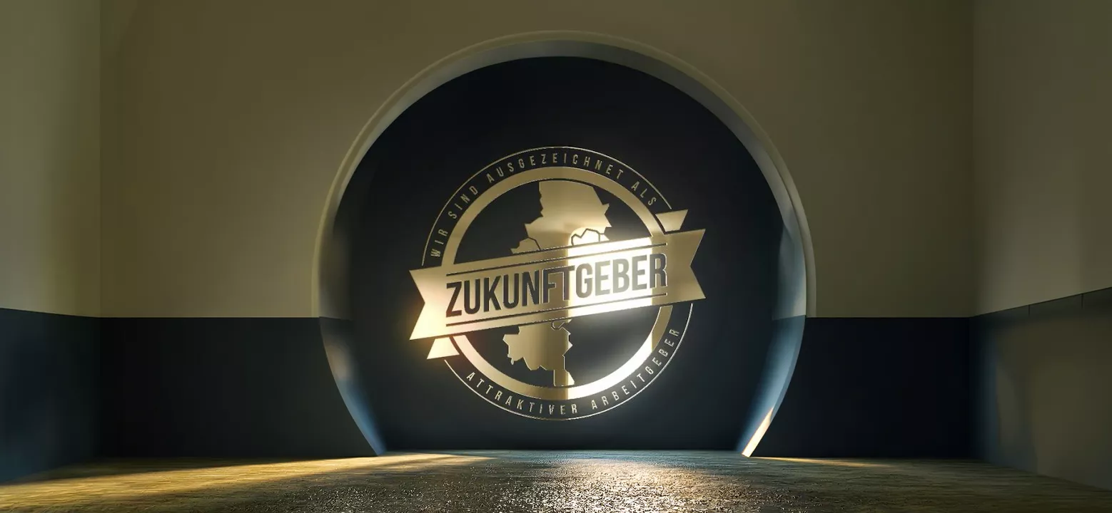 A round wall illuminated with a logo and the inscription ZUKUNFTGEBER in an empty, modern room.
